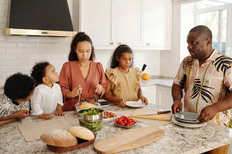 Family preparing a meal together at the kitchen counter